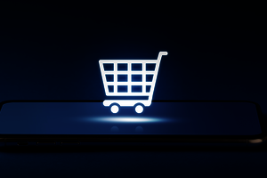 Representation of a shopping cart icon hovering over a smartphone