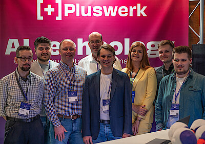 The +Pluswerk team at the booth at Pimcore Inspire 2024